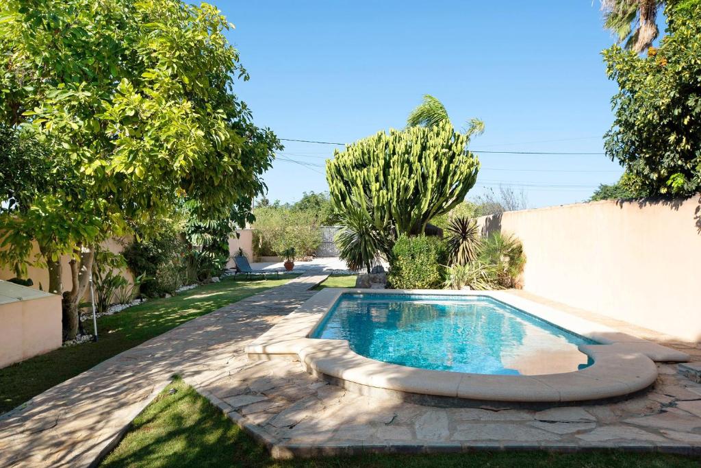 a swimming pool in the backyard of a house at Chalet Rural El Chorrillo in Conil de la Frontera