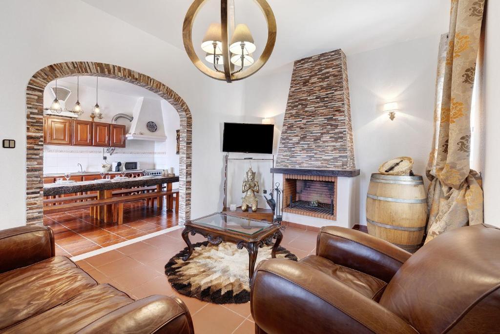 a living room with a couch and a fireplace at Casa Castelão in Palmela