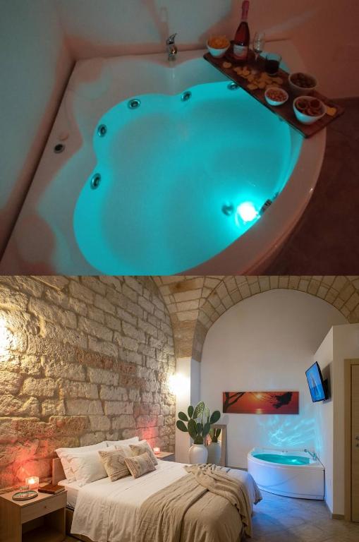 a bedroom with a bed and a bath tub at Salento Houses & Idro Suites in Nardò