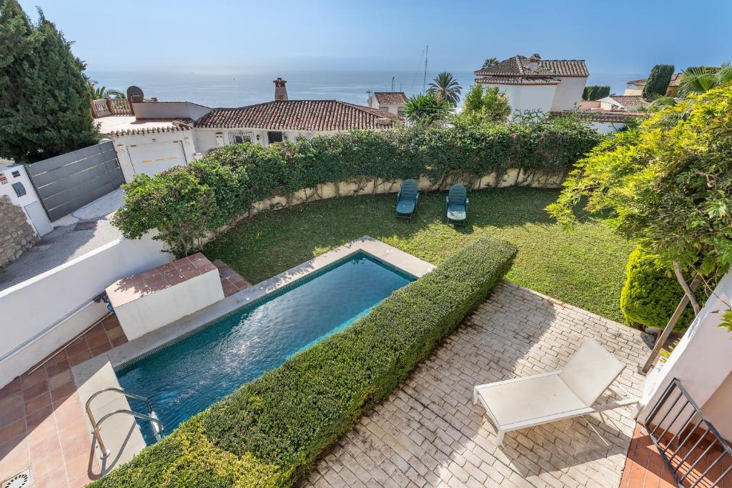 a swimming pool in the yard of a house at Apartamentos Villa Martinez in Salobreña
