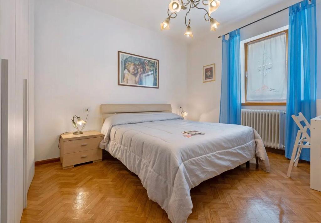 a bedroom with a bed and a table and a window at Camera Meridiana in Roncone