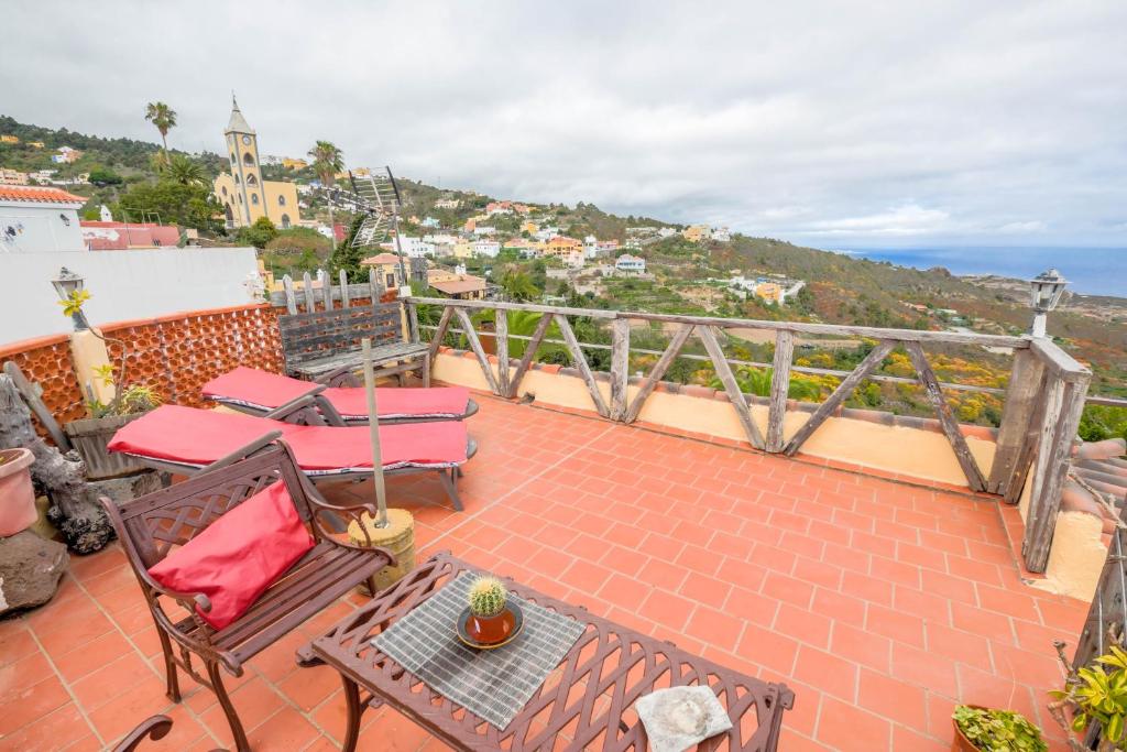 a balcony with a table and chairs on a roof at Casa Carmela in La Guancha