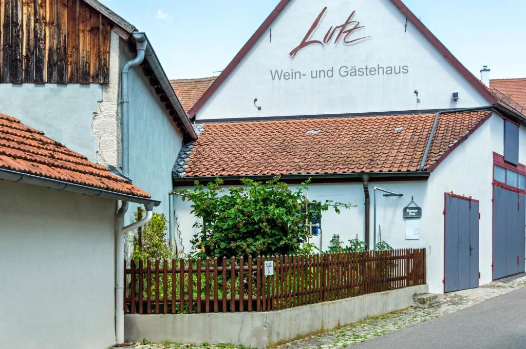a building with a sign on the side of it at Wein- und Gästehaus Lutz in Iphofen