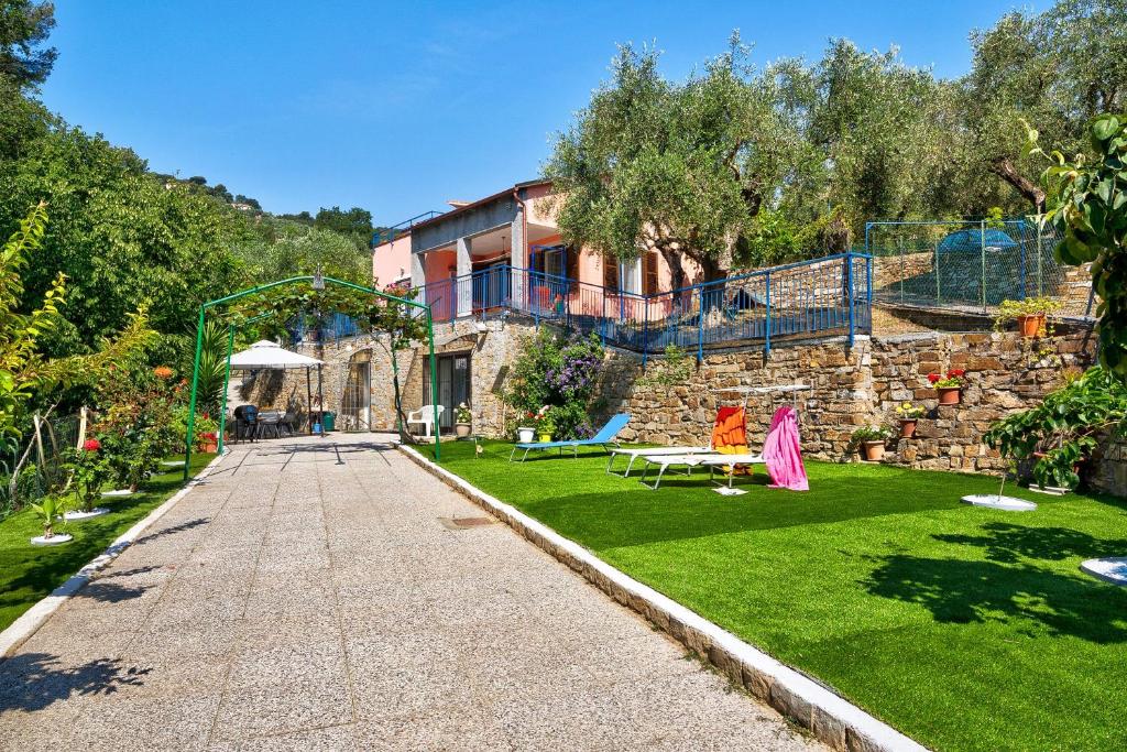 a garden with a house and a playground at Casa Taggiasca in Diano Marina