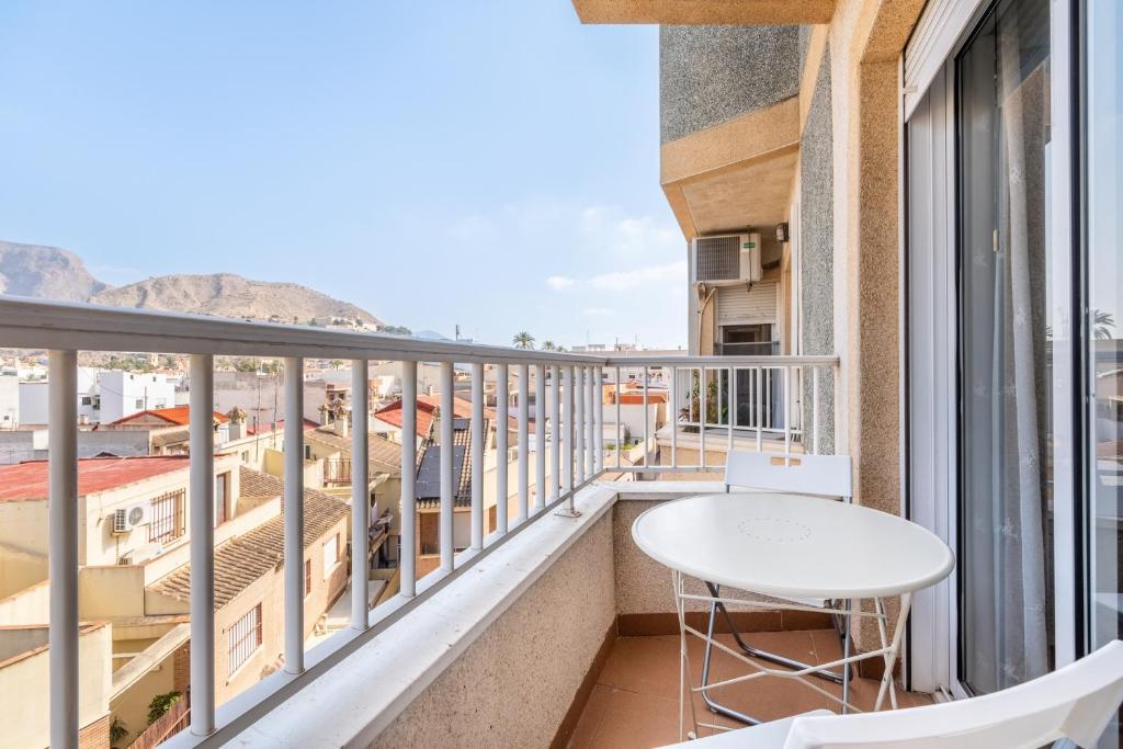 a balcony with a table and a view of the ocean at La Gimena in Orihuela