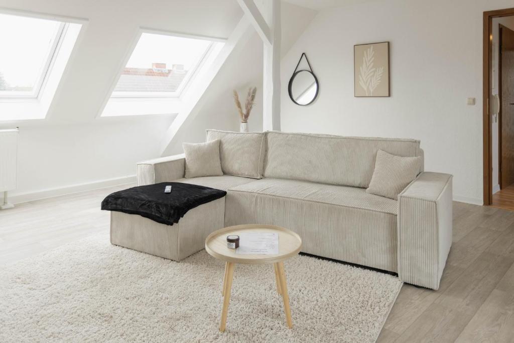 a living room with a couch and a table at Cityloft für Stilvolle in Dessau