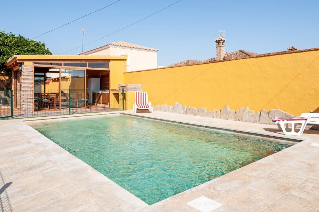 a swimming pool in the backyard of a house at Casa Chiqui - solo familias in Conil de la Frontera