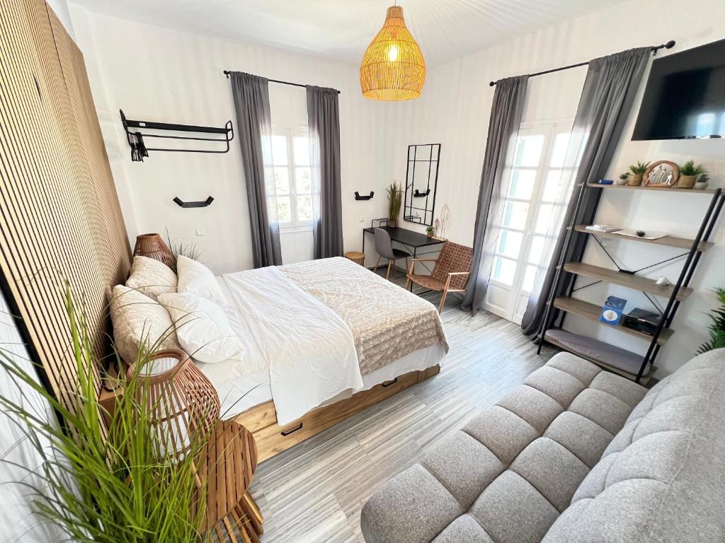 a bedroom with a bed and a couch at aeolian blu 9 in Parikia