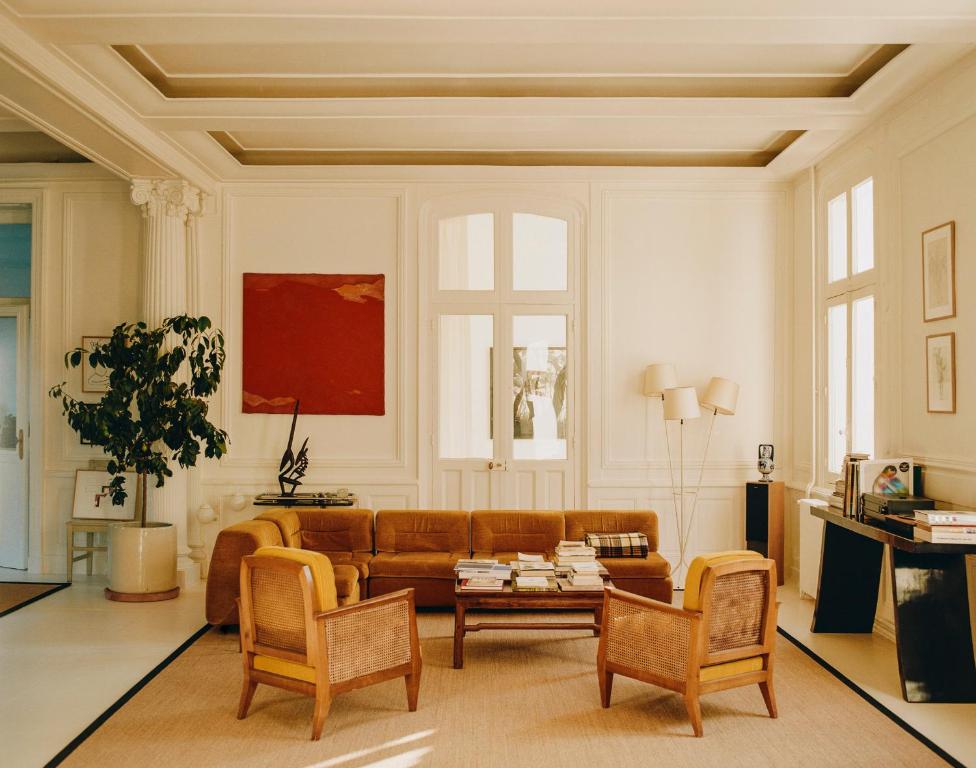 a living room with a brown couch and chairs at CHB - Château de la Haute Borde in Rilly-sur-Loire