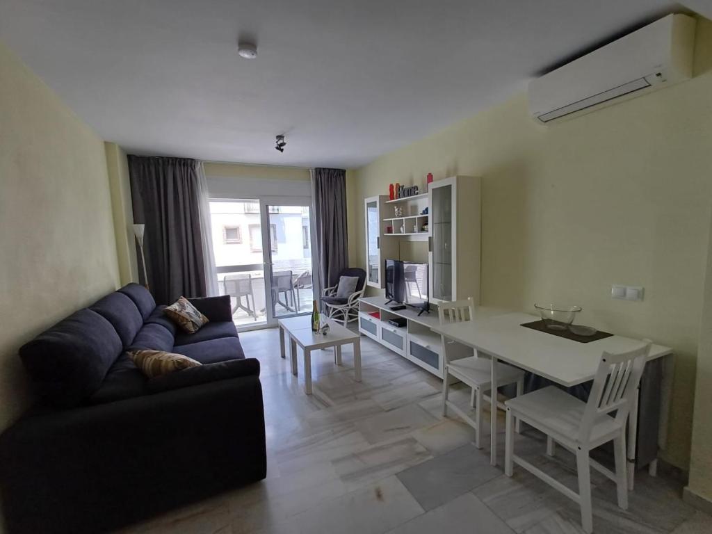 a living room with a couch and a table at Casa Cox Laguna Beach Torrox Costa in Torrox Costa