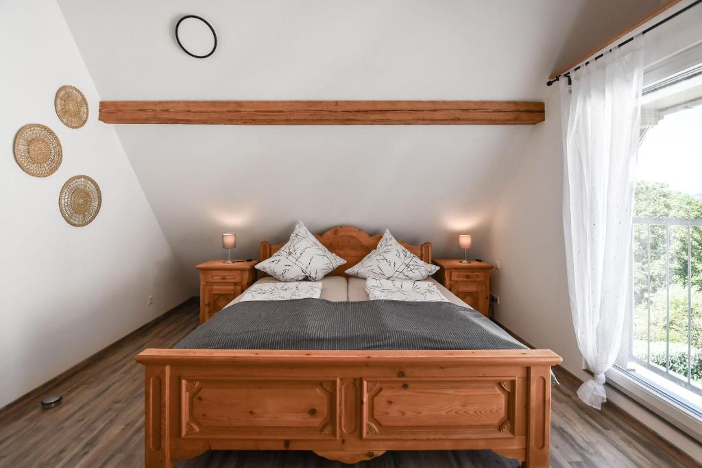 a bedroom with a wooden bed and a window at Ferienwohnung zum Krummholz in Fischerbach