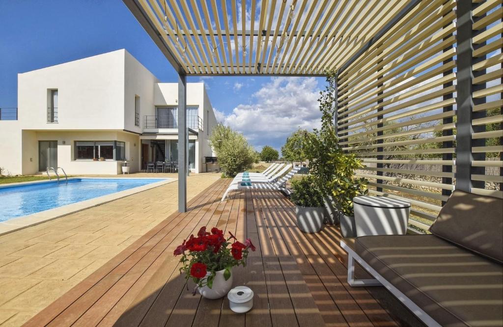 a wooden deck with flowers and a swimming pool at Caleu in Binissalem