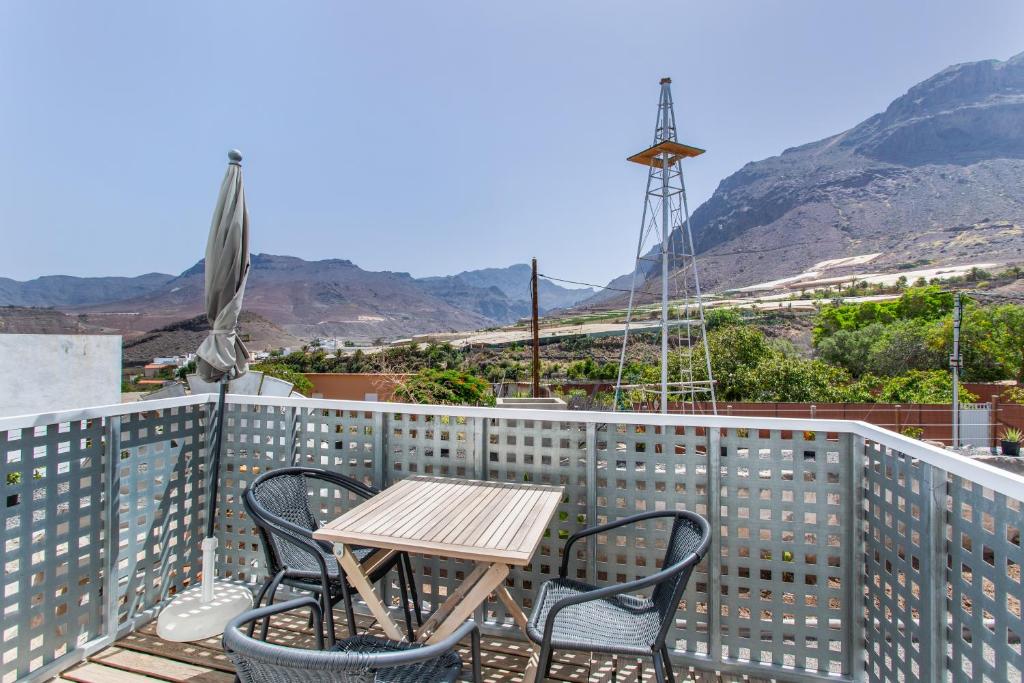 a table and chairs on a balcony with a windmill at El Blanquizal A in San Nicolás