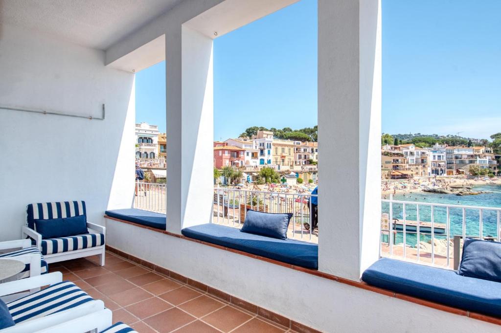 a balcony with a view of the water and buildings at Casa dins el Mar en Calella in Calella de Palafrugell