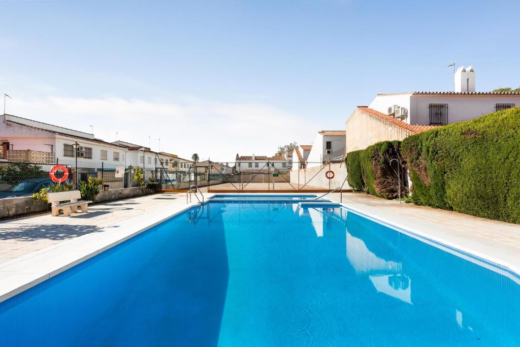 a large blue swimming pool in a building at La Casa de la Cala del Moral in Cala del Moral