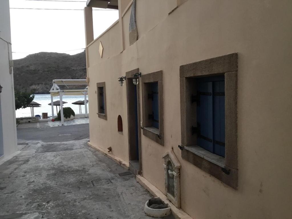 a building with two windows on the side of it at Emma's studio house by Kapsali beach in Kapsali