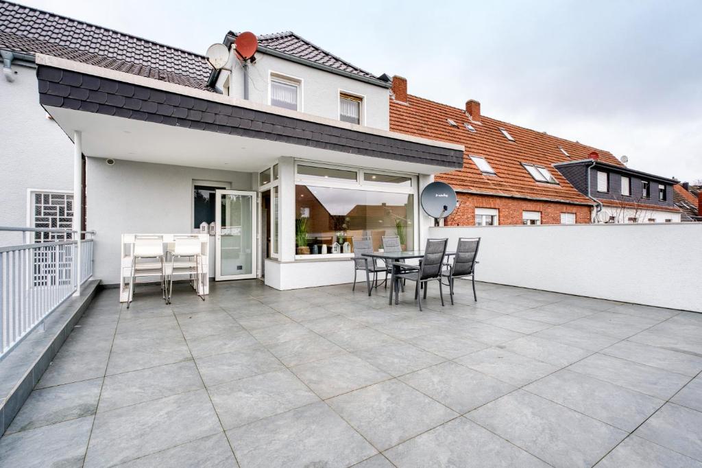 a patio with chairs and a table on a balcony at Stadtquartier Ahaus in Ahaus