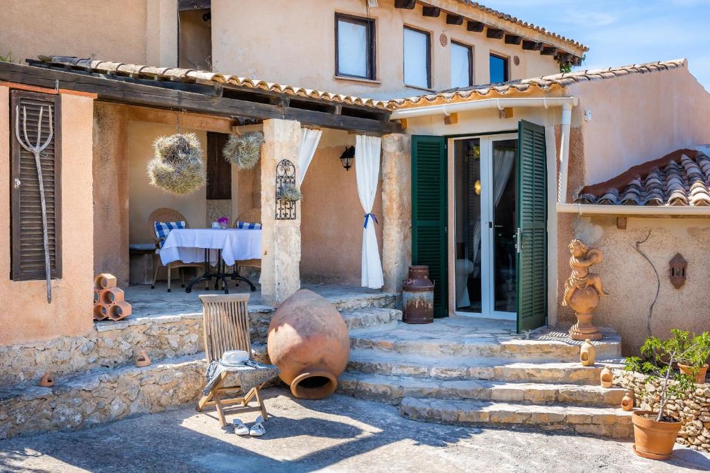 a house with a patio with a table and chairs at Apartment Adults Only - Mallorca in Manacor