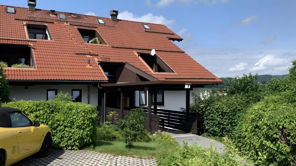 a house with a yellow car parked in front of it at Ferienwohnung Voges mit Pool in Bad Lauterberg