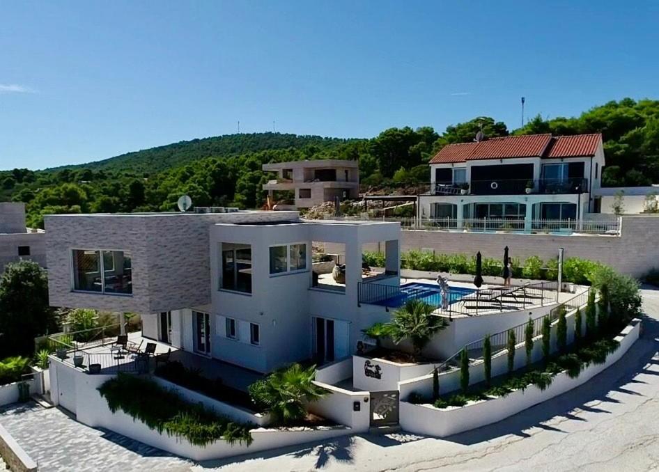 a large house with a swimming pool in front of it at Villa Jasmina in Stomorska