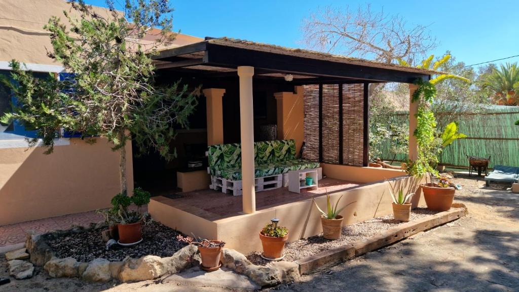 a pavilion with potted plants in a yard at Casita in Illes Balears