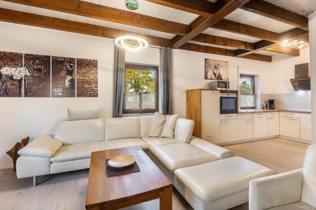 a living room with a couch and a table at Landhaus Sophie in Frielendorf