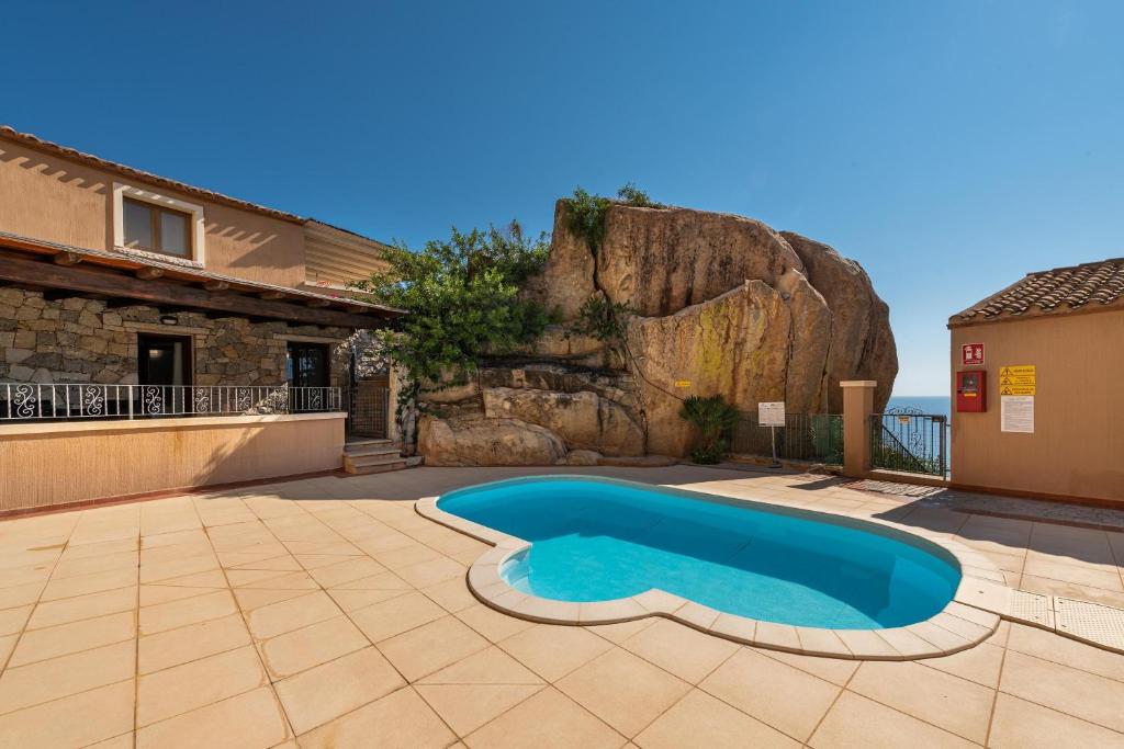 a swimming pool in the yard of a house at Villa Simonetta n9 in Costa Rei