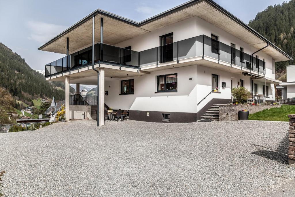 a house on a hill with a large driveway at Haus Florian Ski-in and Ski-out in See