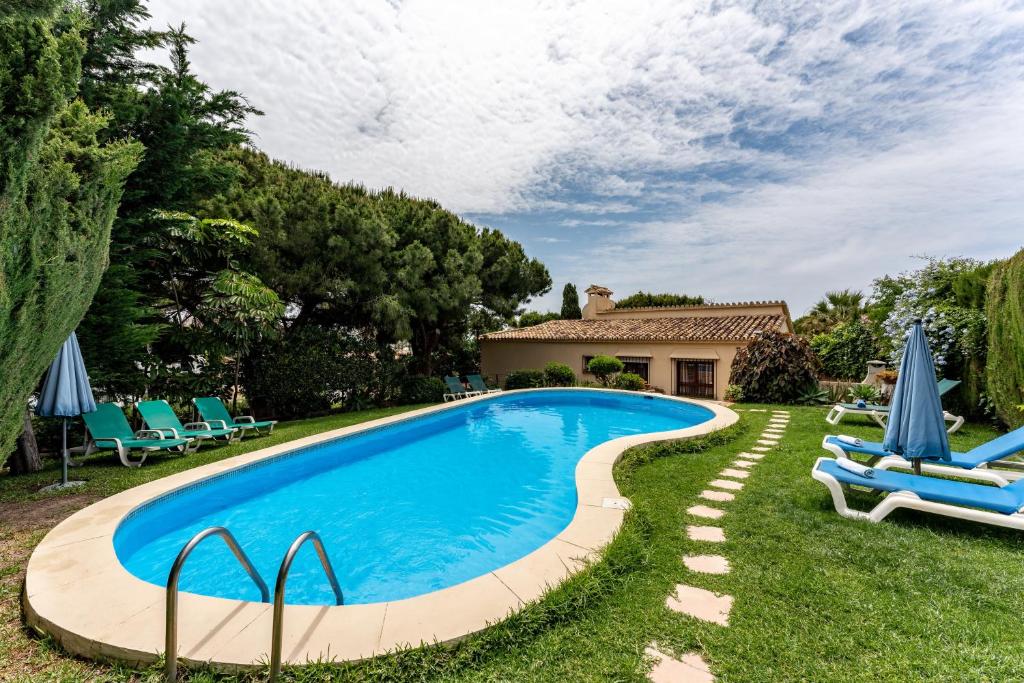 a swimming pool in the yard of a house at Art Gallery House in La Cala de Mijas