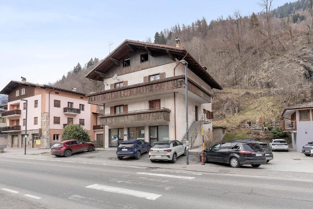 a building on the side of a street with parked cars at Bnb and Breakfast Pellizzano in Pellizzano