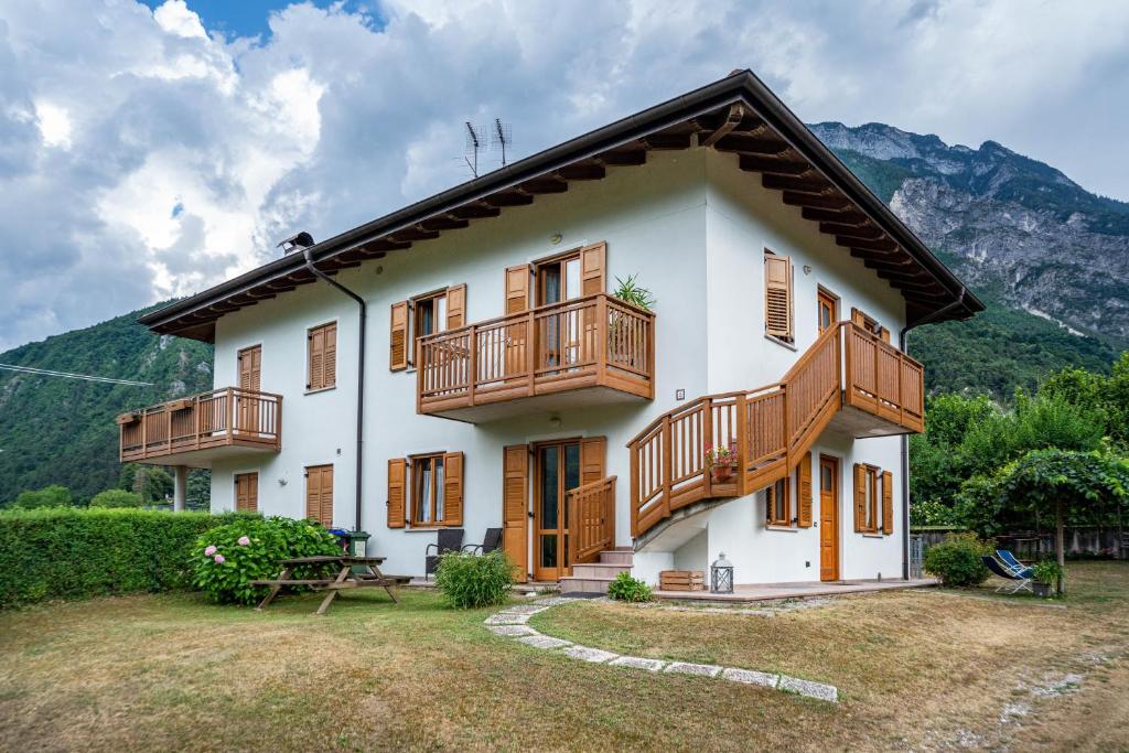 a house with wooden balconies on the side of it at Apartment Villa Irma in Levico Terme