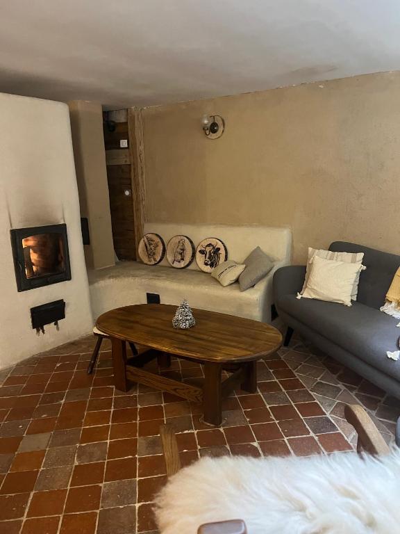 a living room with a couch and a coffee table at Gite les 4 Saisons in Ombre