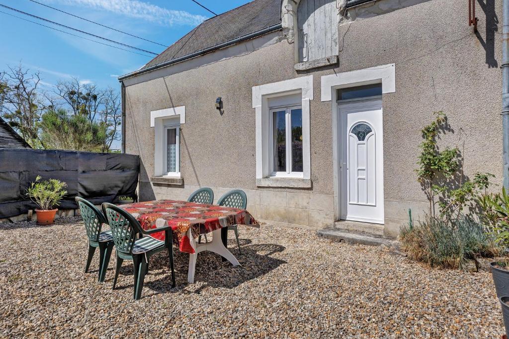 a table and chairs in front of a house at Gîte Le Trotteur in Monteaux