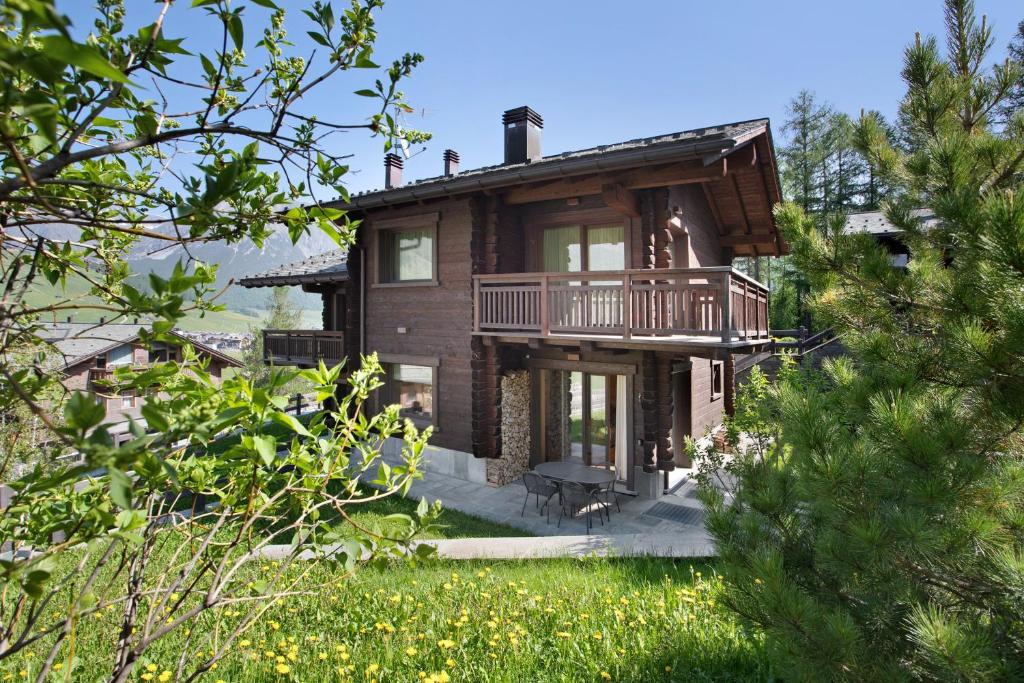 a large brick house with a balcony on it at Spark Chalet e Spa Livigno in Livigno