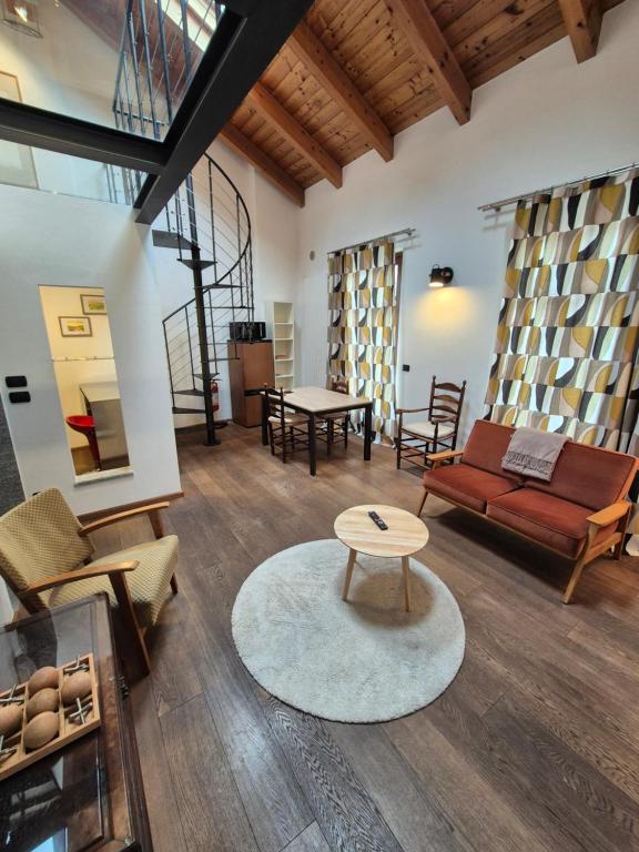 a living room with a couch and a table at Urban Loft Duomo in Alba