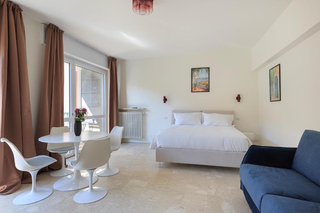 a bedroom with a bed and a table and a couch at La Farmacia in Stresa