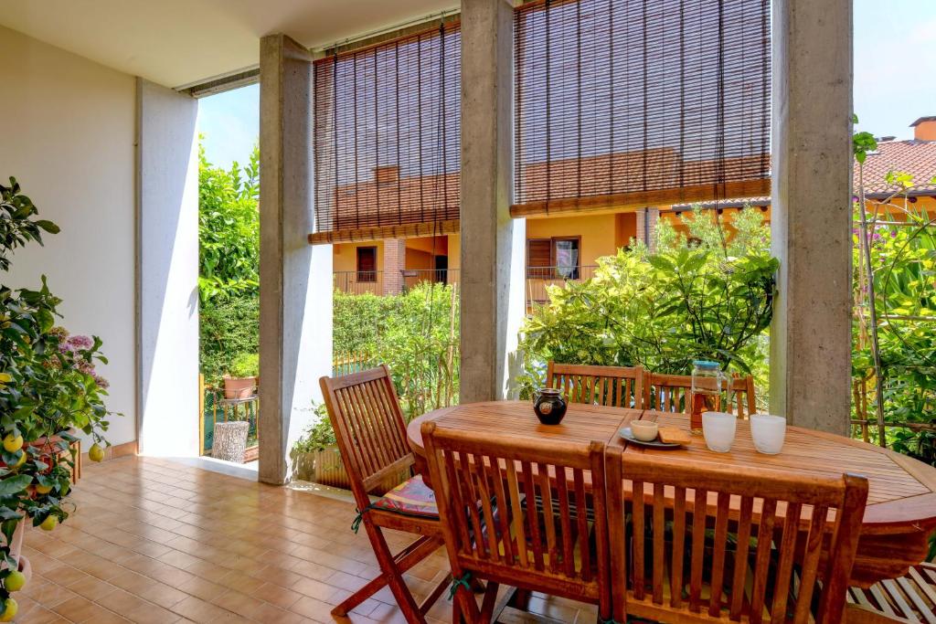 a wooden table and chairs on a patio at Civic 55 in Toscolano Maderno