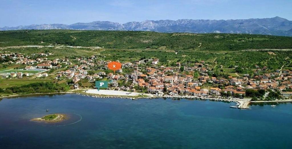 an aerial view of a small town next to a lake at Apartment Travica in Posedarje