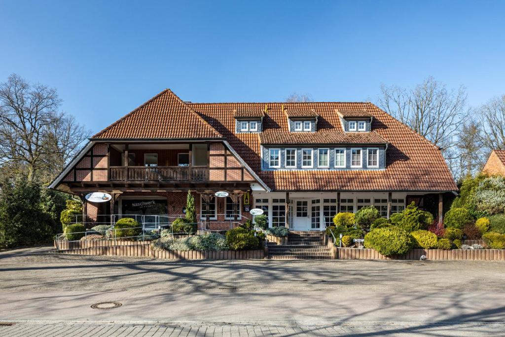 a large house with a gambrel roof at Haus Wacholder in Undeloh