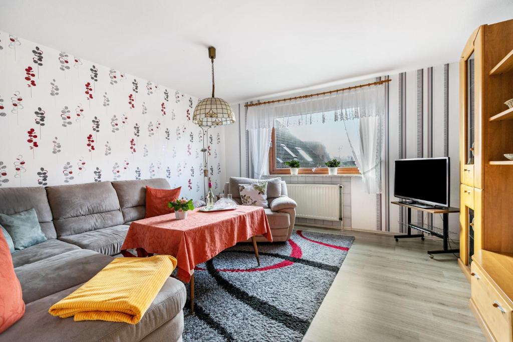 a living room with a couch and a table at Haus Dreeßen in Buchholz