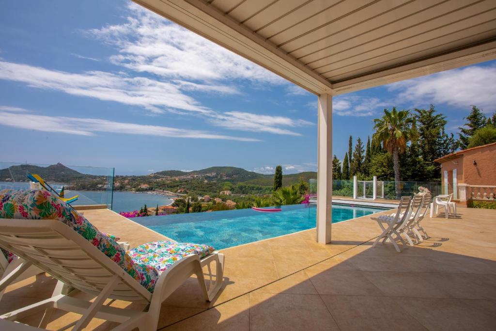 a swimming pool with a chair on a patio at Studio Palmeraie in Saint-Raphaël