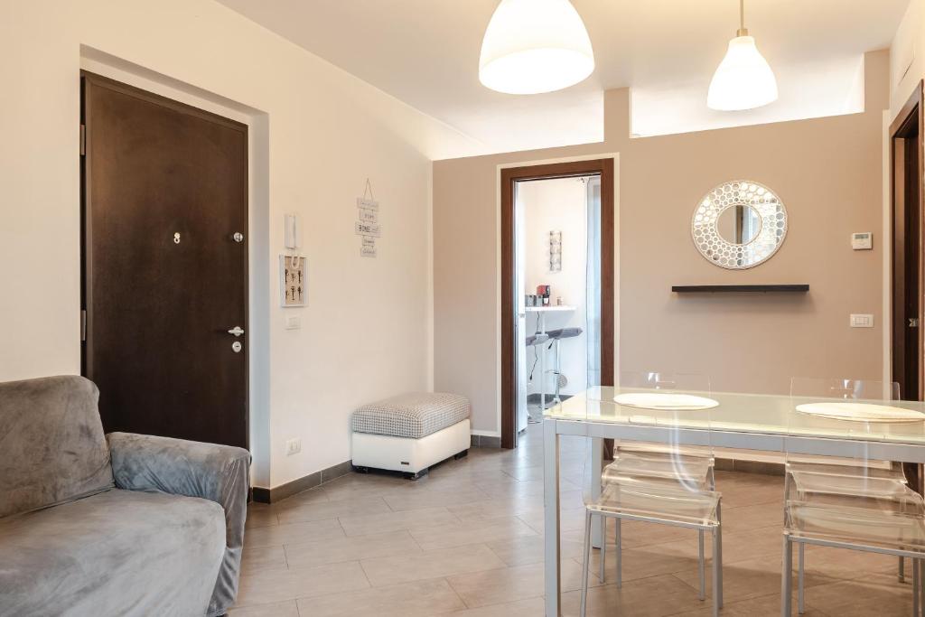 a living room with a glass table and a chair at Beb Pulcino Nero Foiano in Foiano della Chiana