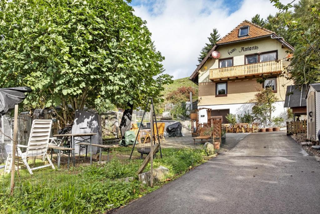 a house with a yard with chairs and a building at Haus Antonis in Triberg