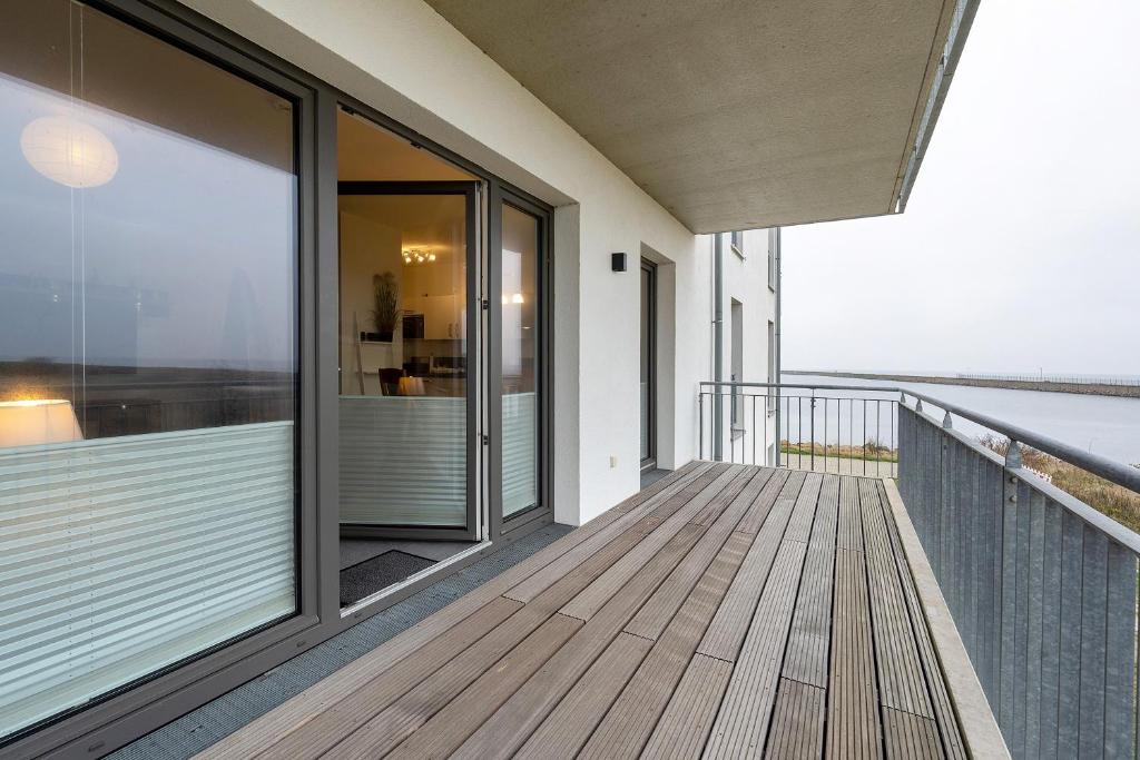 a balcony of a house with a view of the ocean at Seeschwalbe in Olpenitz