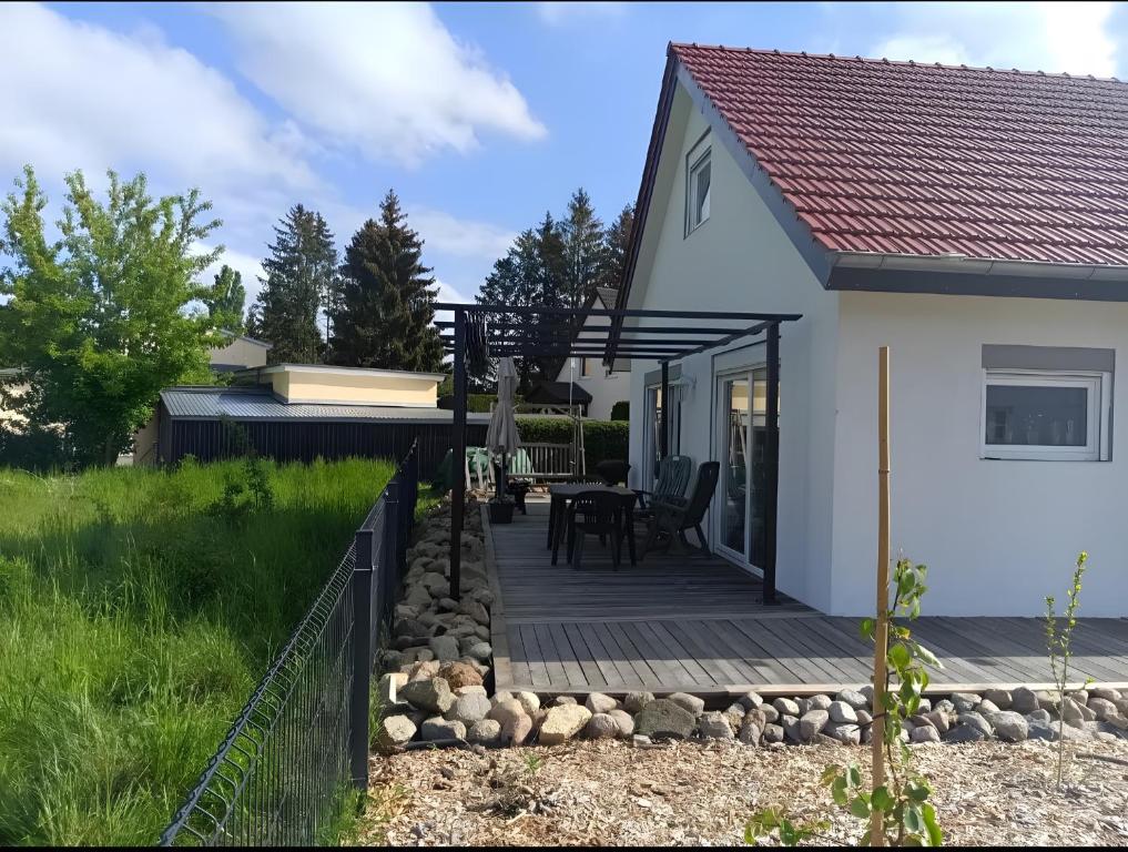 a small white house with a wooden deck at Ferienhaus Schw Agnes in Warin