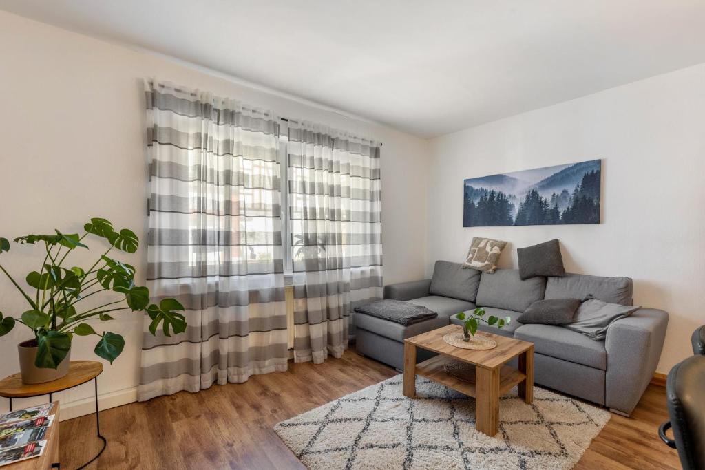 a living room with a couch and a table at Fewo45 in Homberg