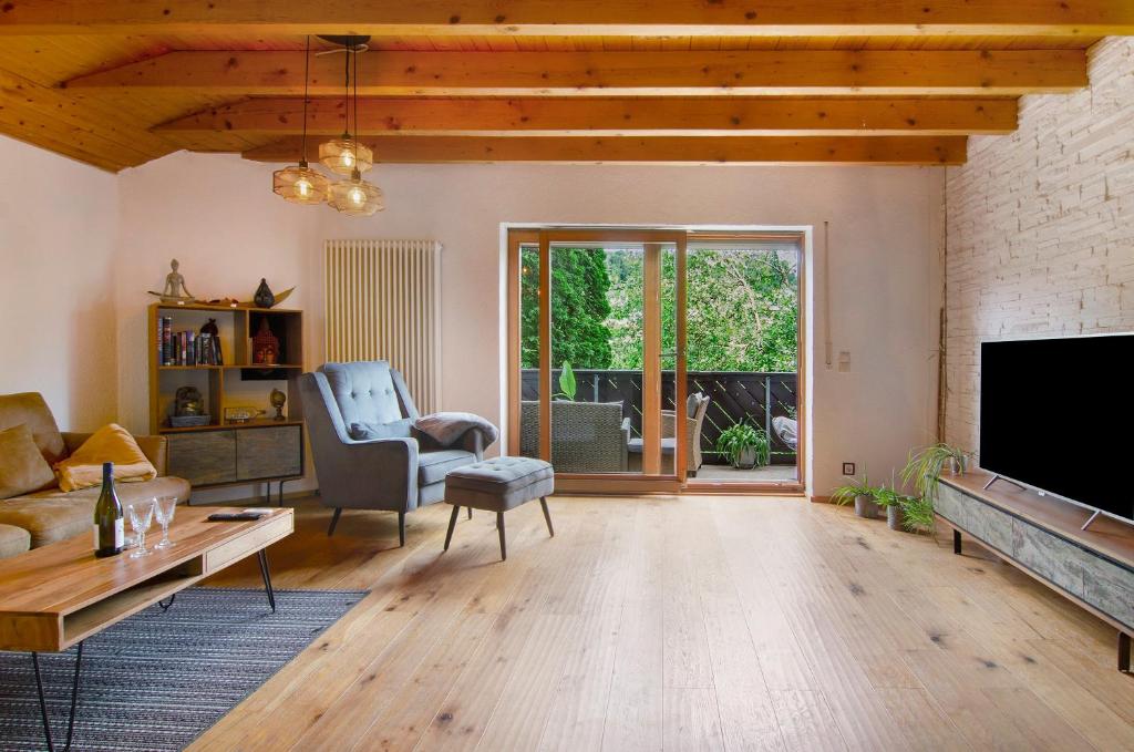 a living room with a couch and a tv at Jogis Paradies In Ruhiger Lage in Stockach