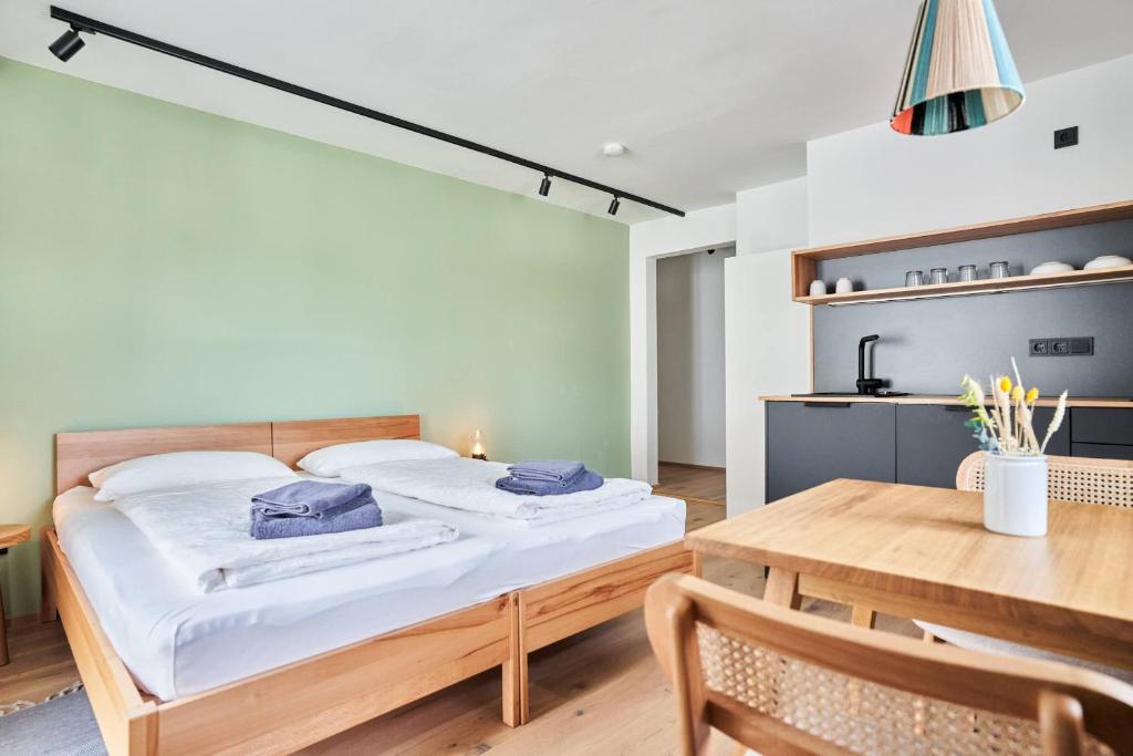 a bedroom with a bed and a wooden table at Alte Seifensiederei - Jane in Bad Tölz
