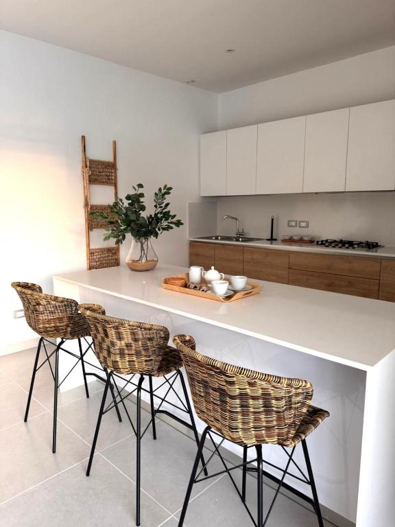 a kitchen with a counter with chairs and a table at Sol de Arena Beachfront, Las Terrenas in Las Terrenas