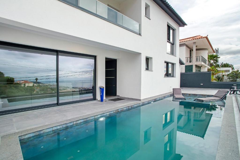 a house with a swimming pool with a view at Villa Angela in Funchal